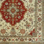 A beautifully intricate Timeless Petals Hand Knotted Area Rug showcasing a classic Persian design. This vintage wool rug features a rich red central medallion with elaborate floral patterns in beige and earth tones. Perfect for adding an elegant touch to dining room carpets, this large square area rug blends tradition with luxury, ideal for those seeking exquisite dining room area rugs.