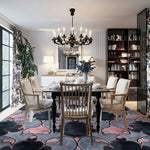 Elegant dining room featuring a Timeless Symmetry Hand Tufted Area Rug. This wool rug, with its vintage and contemporary design in shades of pink and gray, perfectly complements the chic furniture and chandelier. Ideal for living room settings, this 8x10 rug adds a touch of sophistication to any space, making it one of the perfect rugs for a stylish living room.