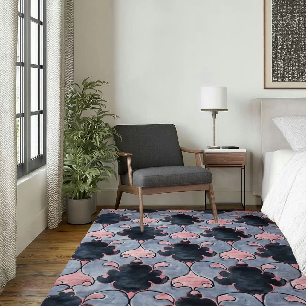 A stylish living room featuring the Timeless Symmetry Hand Tufted Area Rug. This contemporary wool rug showcases a vintage-inspired pattern in shades of pink, black, and gray. Perfectly sized at 8x10, it adds elegance to the wooden floor, complementing the modern furniture and decor. Ideal for those looking for sophisticated rugs for living room aesthetics.