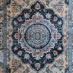Top view of a Timeless Treasure Hand Tufted Rug showcasing an intricate vintage design with rich floral patterns in navy and beige tones, ideal for a living room or dining room. This wool area rug adds elegance and warmth to any space, making it a perfect choice for dining room carpets and living room area rugs.