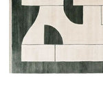 Top view of a contemporary wool area rug featuring an abstract design in black and beige tones, ideal for rugs for living room. This stylish living room rug, sized 8x10, adds a modern touch to any space.