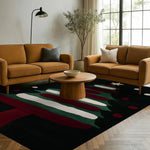 A cozy living room featuring a stylish area rug with abstract patterns in shades of red, green, and white. The wool rug complements the modern decor with two mustard-colored sofas, a round wooden coffee table, and a floor lamp, creating an inviting atmosphere. Ideal for living room rugs 8x10, this area rug adds warmth and elegance to any space, making it perfect for both home and office settings.