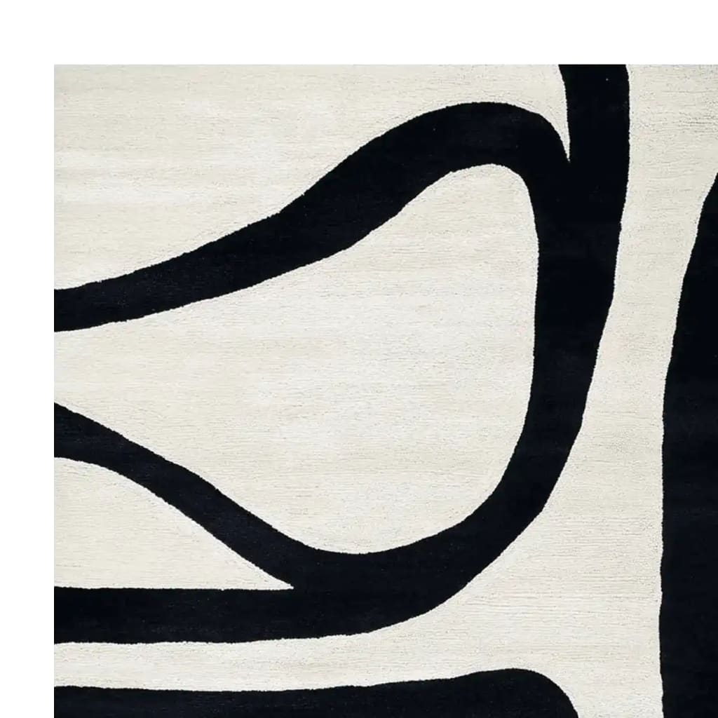 Contemporary wool area rug featuring a striking black abstract design on a soft white background, perfect for modern living rooms.