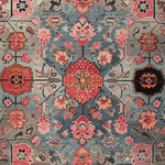 Vibrant hand-tufted floral area rug featuring intricate mosaic patterns in rich shades of red, blue, and pink, perfect for large living rooms. This wool rug adds a touch of elegance and warmth, making it an ideal choice for area rugs for living room settings.