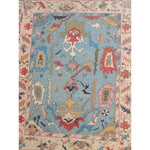 Traditional floral hand-tufted wool area rug in blue, featuring intricate patterns and vibrant colors. Ideal for enhancing the elegance of a living room, this rug adds a touch of sophistication and warmth. Perfect for those seeking quality area rugs for living rooms.