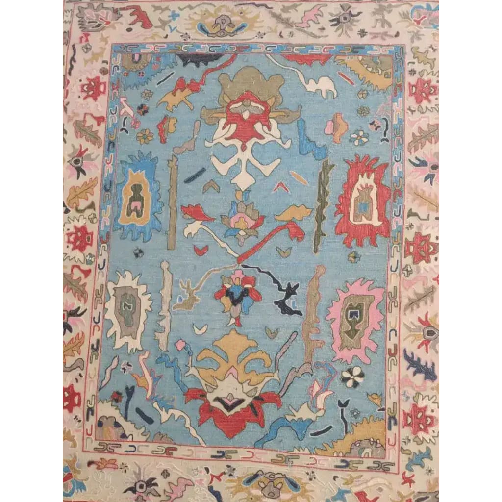 Traditional floral hand-tufted wool area rug in blue, featuring intricate patterns and vibrant colors. Ideal for enhancing the elegance of a living room, this rug adds a touch of sophistication and warmth. Perfect for those seeking quality area rugs for living rooms.