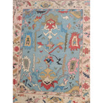 Traditional floral hand-tufted wool area rug in blue, featuring intricate patterns and vibrant colors. Ideal for enhancing the elegance of a living room, this rug adds a touch of sophistication and warmth. Perfect for those seeking quality area rugs for living rooms.
