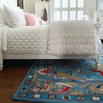 A beautifully designed traditional floral hand-tufted wool rug in blue, placed partially under a bed in a bright living room. This elegant area rug adds a touch of luxury and comfort, making it an ideal choice for rugs in living rooms.