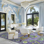 A luxurious living room featuring a Traditional Floral Hand Tufted Wool Rug in purple. This elegant area rug adds a vibrant touch to the sophisticated space with its intricate floral patterns, perfect for both office and living room settings. The room is adorned with plush white chairs and a chic glass table, creating a harmonious blend of comfort and style.