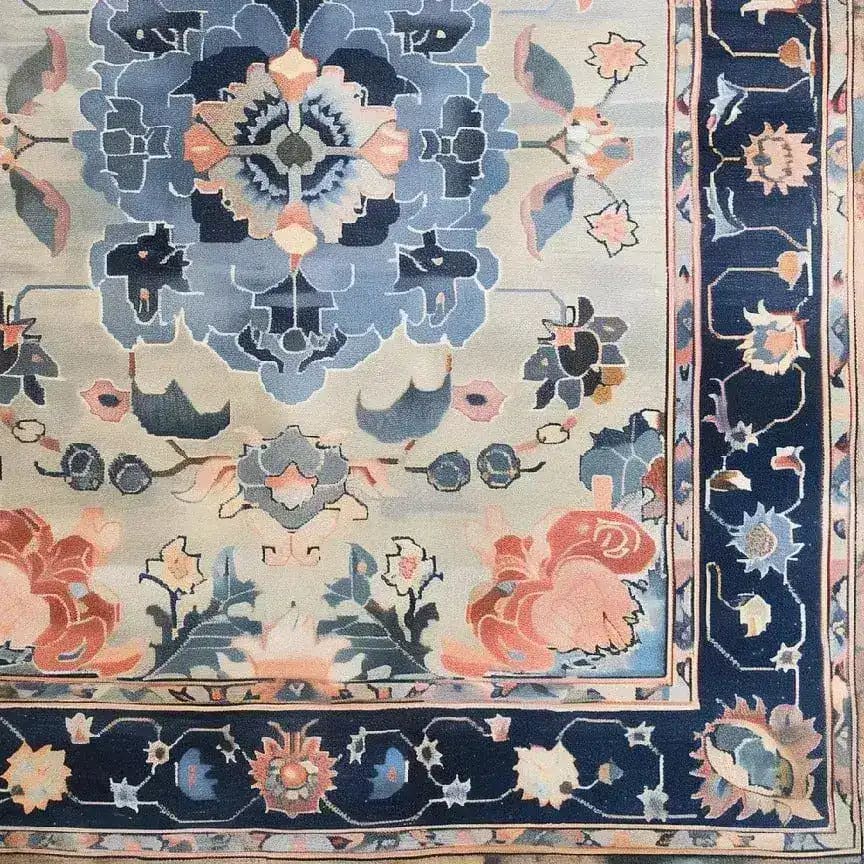 Top view of the Tranquil Tapestry Hand Tufted Area Rug, showcasing an intricate floral design in soothing blue and peach tones. This wool rug is perfect for adding elegance to dining room or bedroom spaces.