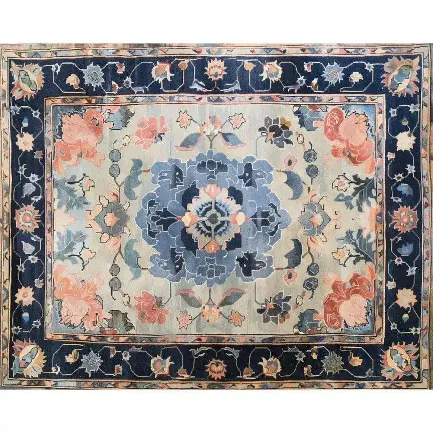 The Tranquil Tapestry Hand Tufted Rug features an elegant floral design with soft blues and warm pinks, perfect for adding a touch of sophistication to dining rooms or bedrooms. This wool area rug blends seamlessly with various interior styles, making it an ideal choice for those seeking quality dining room area rugs or bedroom area rugs.