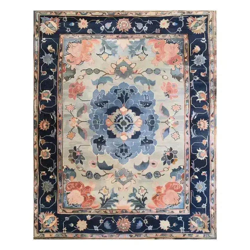 The Tranquil Tapestry Hand Tufted Rug features a stunning floral design with rich blue and soft pink hues. This wool area rug is perfect for adding elegance to dining rooms or bedrooms, enhancing any space with its intricate patterns.