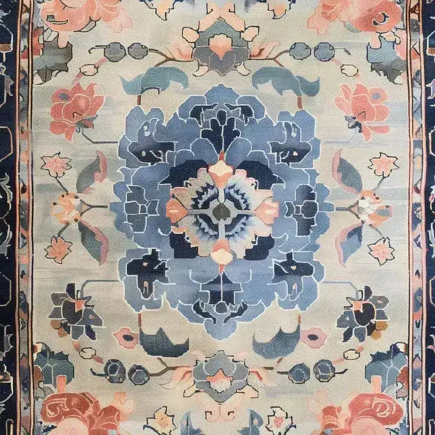 A beautifully designed hand-tufted area rug featuring a central floral motif in shades of blue, pink, and beige, perfect for adding elegance to dining rooms and bedrooms. This wool rug showcases intricate patterns, making it an ideal choice for dining room area rugs or bedroom area rugs.