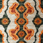 A vibrant hand-tufted area rug with a tribal tapestry design, featuring intricate patterns in orange, red, and green hues. Ideal for dining rooms, this wool rug adds a contemporary flair to any office or dining room setting, offering a stylish and cozy carpet option.