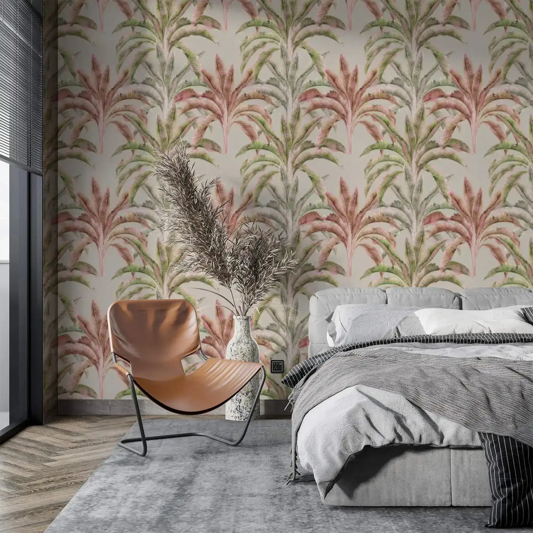Tropical banana grove wallpaper in a modern bedroom with grey bed, leather chair and pampas grass