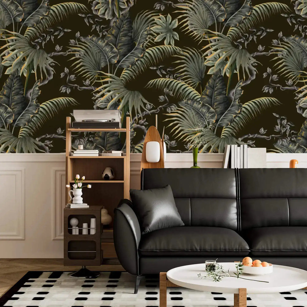 Tropical canopy wallpaper with green palm and monstera leaves above wainscoting in a living room with black sofa