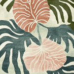 Close-up view of the Tropical Echo Drift Hand Tufted Area Rug, showcasing an abstract floral pattern with earthy tones of green and pink. This contemporary rug is perfect for adding a stylish touch to living rooms. Crafted from wool, it's available in an 8x10 size, offering a blend of comfort and elegance.