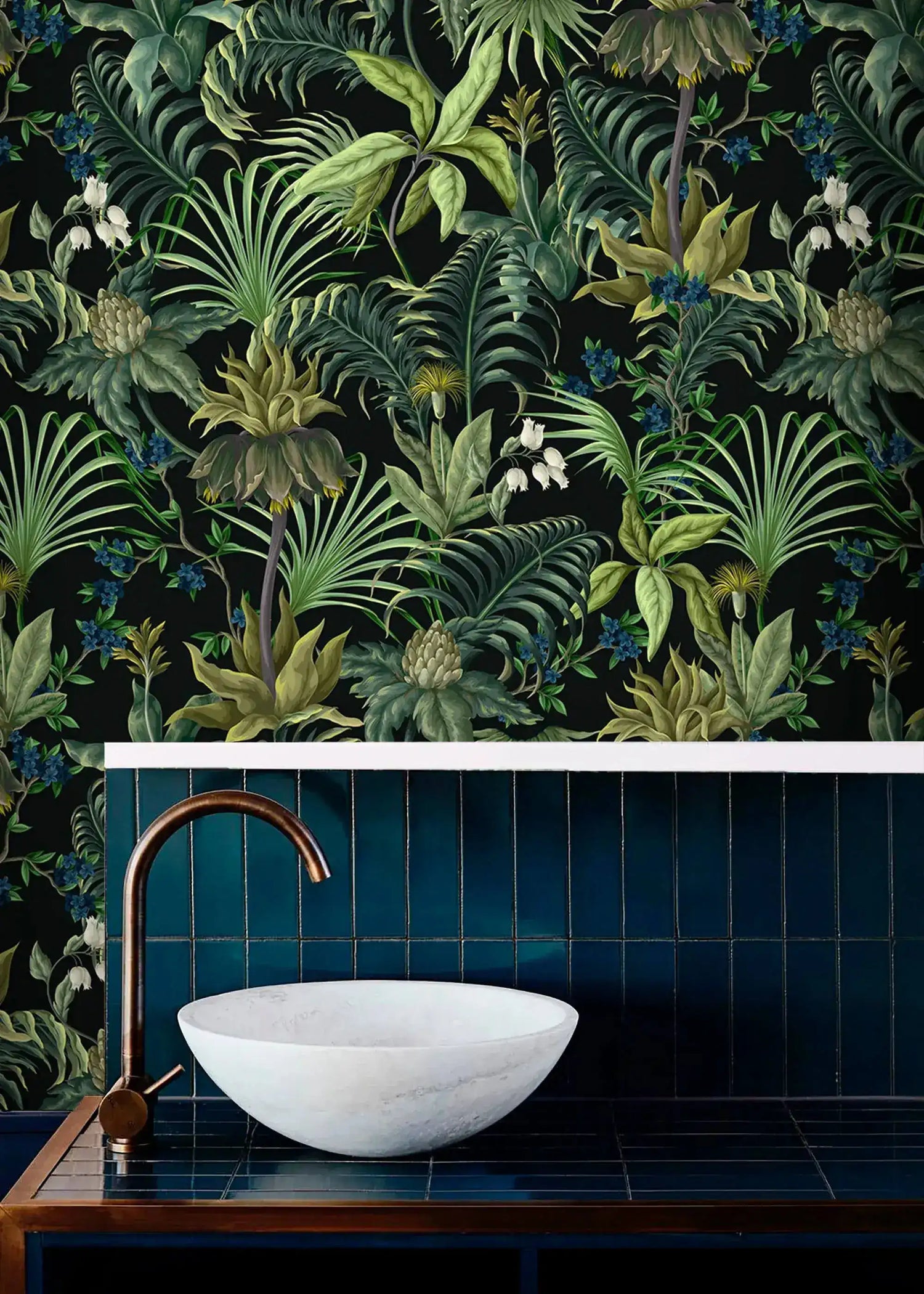 Tropical jungle canopy wallpaper in bath above navy tile with white stone vessel sink and copper tap