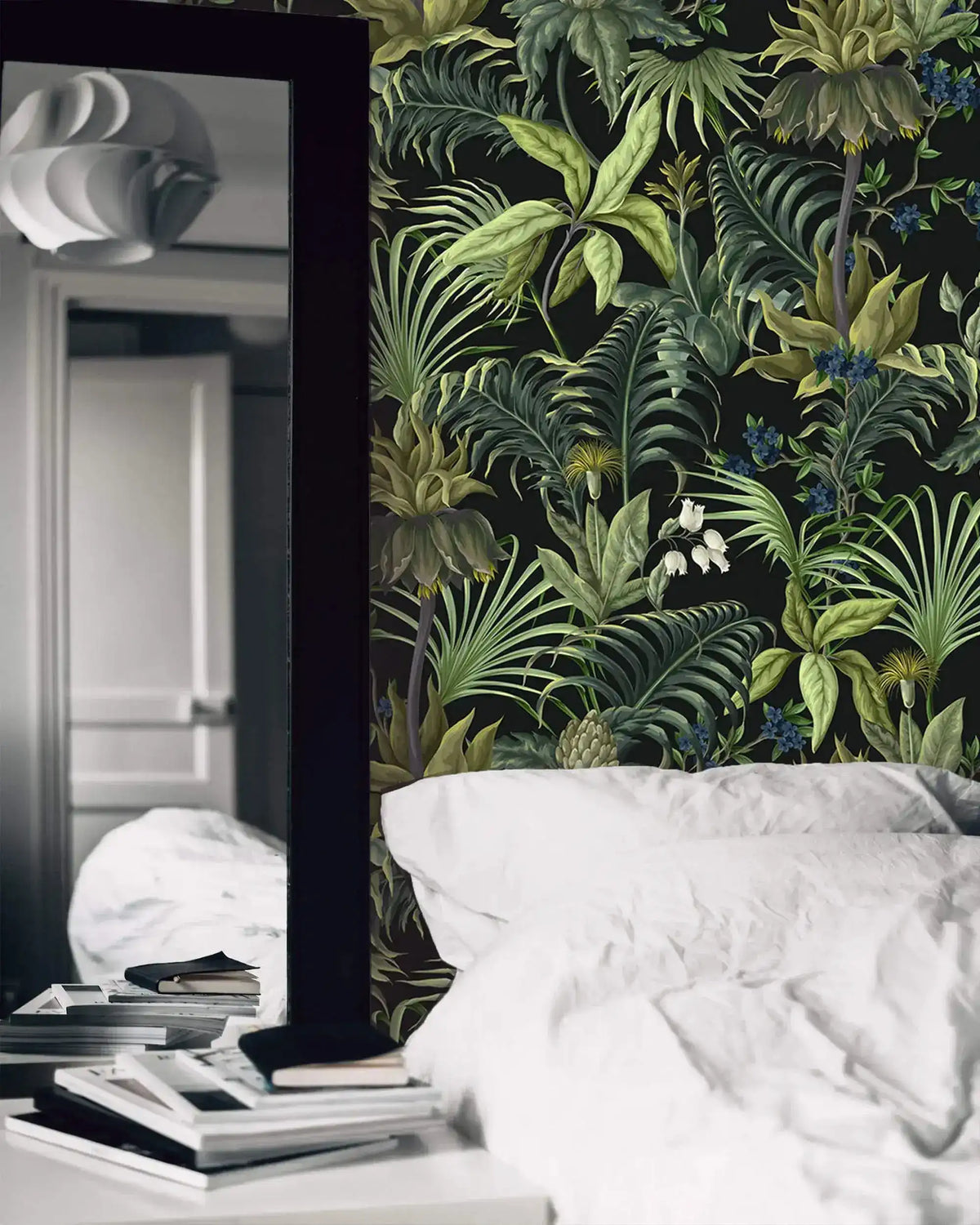 Tropical jungle canopy wallpaper in bedroom with white bedding and leaning floor mirror