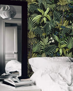 Tropical jungle canopy wallpaper in bedroom with white bedding and leaning floor mirror