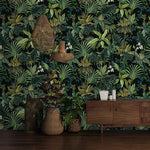 Tropical jungle canopy wallpaper, lush green ferns and palms on dark ground with rattan baskets and sideboard