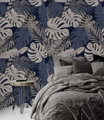 Tropical midnight leaves wallpaper on navy as headboard wall, paired with charcoal linen bedding and hairpin nightstand