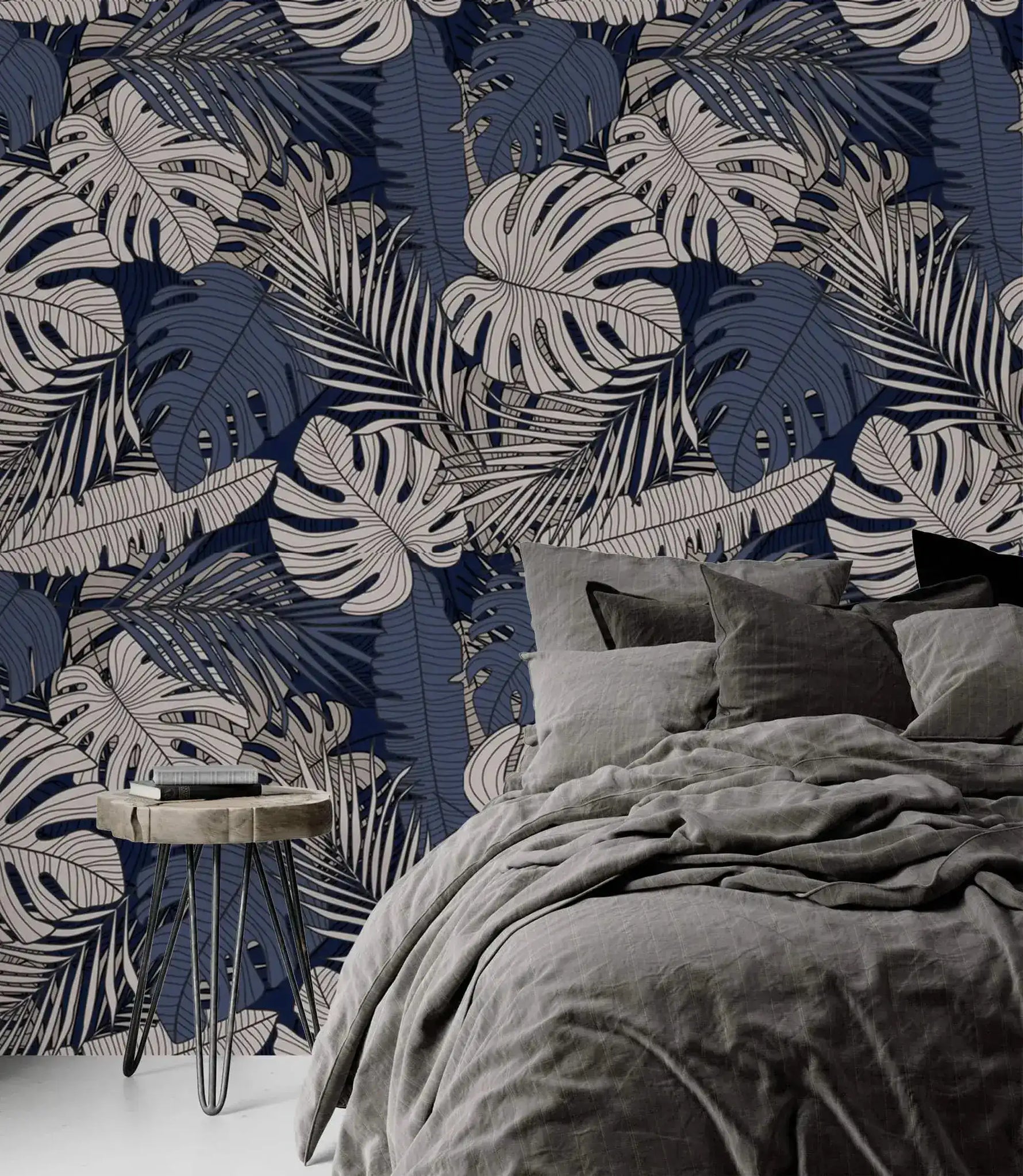 Tropical midnight leaves wallpaper on navy as headboard wall, paired with charcoal linen bedding and hairpin nightstand
