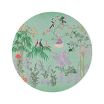 Round rug with floral and bird design on a light green background