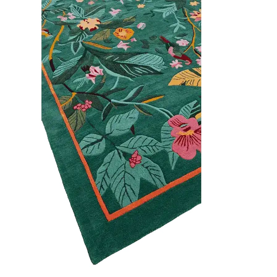 A vibrant Tropical Treasure hand-tufted wool rug, perfect for a large living room. This 4 x 6 ft area rug features a lush, colorful floral design with green leaves and pink flowers, ideal for adding a touch of nature to your living space.