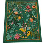 Vibrant Tropical Treasure Hand Tufted Wool Rug measuring 4 x 6 ft, showcasing a lush floral design. Perfect for large living rooms, this area rug features an exquisite array of colorful flowers and leaves set against a rich green background, offering a touch of nature to your living room decor.