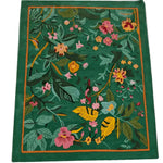 Vibrant Tropical Treasure Hand Tufted Wool Rug measuring 4 x 6 ft, showcasing a lush floral design. Perfect for large living rooms, this area rug features an exquisite array of colorful flowers and leaves set against a rich green background, offering a touch of nature to your living room decor.