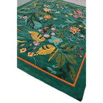 Vibrant Tropical Treasure Hand Tufted Wool Area Rug, ideal for large living rooms. This 4 x 6 ft floral rug features lush green tones with intricate floral patterns, perfect for enhancing any living room space with a touch of nature.
