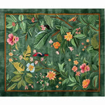 The Tropical Treasure Hand Tufted Wool Rug features a lush, green background adorned with vibrant floral patterns and tropical birds. This large area rug is perfect for enhancing the elegance of a dining room, offering a blend of color and style that complements formal dining room settings. Ideal for those seeking dining room carpets with a touch of nature-inspired design.