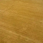 This image features the Turmeric Artic Geo Modern Hand Tufted Wool Rug, a large area rug perfect for contemporary living rooms. The wool rug displays an intricate geometric pattern in a warm turmeric hue, showcasing its modern design and high-quality craftsmanship.