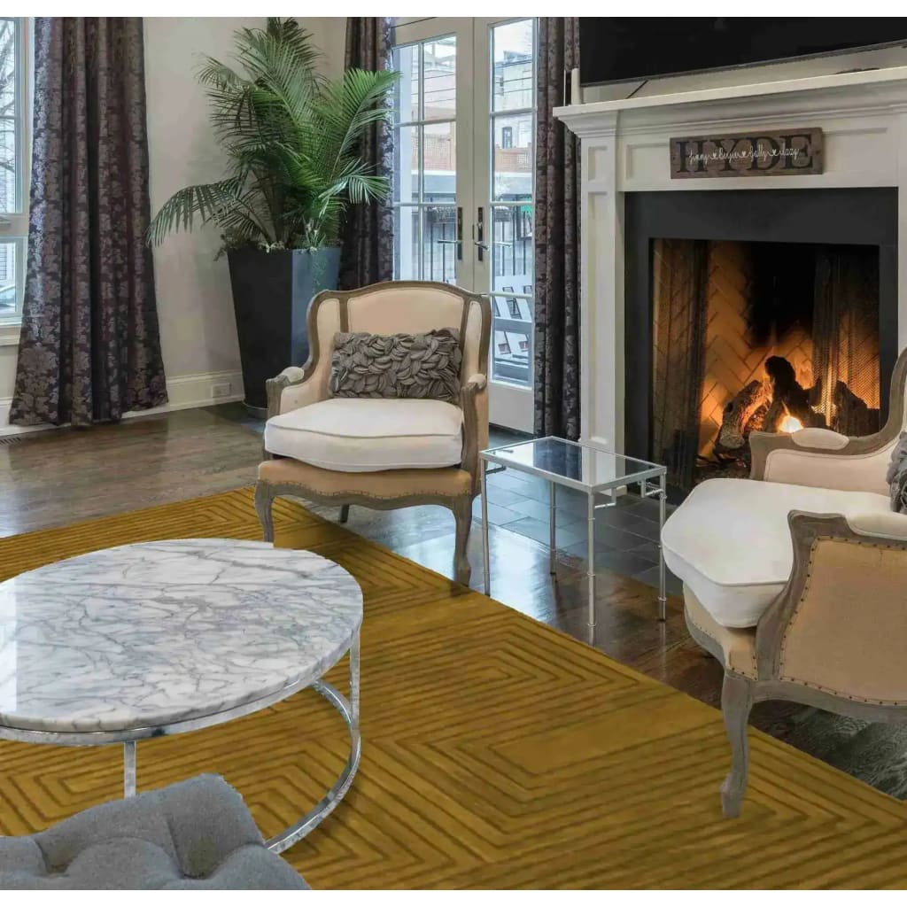 Elegant living room featuring the Turmeric Artic Geo Modern Hand Tufted Wool Rug in a 9 x 12 size. This large area rug, perfect for contemporary living rooms, showcases a geometric design in warm turmeric tones, adding a touch of sophistication. The wool rug complements classic furniture and a cozy fireplace, creating an inviting atmosphere.