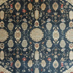 A stunning Turquoise Tradition Hand Knotted Area Rug featuring intricate floral patterns typical of Persian rugs. This vintage rug showcases a rich array of colors on a dark background, perfect as a large living room rug to add elegance and style.