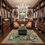 Luxurious walk-in closet with wooden shelves, chandeliers, and floral rug.