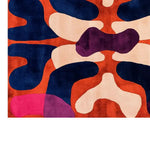 A stunning Twilight Horizon Embrace hand-tufted wool area rug featuring a bold, abstract design with rich colors of navy, orange, pink, and purple. Perfect for adding a contemporary touch to large living rooms, this wool rug offers a unique blend of style and comfort.