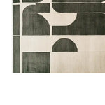 This image features the Twilight Mosaic Knotted Wool Rug, an exquisite area rug designed for large living rooms. The contemporary rug showcases an abstract pattern with bold geometric shapes in neutral tones, highlighting its modern appeal. Crafted from high-quality wool, this rug offers a soft texture and adds a stylish touch to any space.