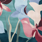 Close-up of the Twisted Blossom Field Hand Tufted Area Rug featuring a vibrant floral design in shades of blue, pink, and green. This contemporary rug adds a pop of color, perfect for large living room spaces, offering a stylish wool rug option for those seeking area rugs for living room decor.