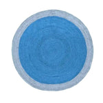 Top view of a Two Toned Blue Round Jute Rug, perfect for adding a stylish touch to a large living room. This area rug features a central dark blue circle surrounded by a lighter blue outer ring, showcasing the natural texture of jute in a round design.