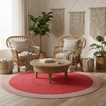 Living room with wicker chairs, wooden coffee table, and red rug.