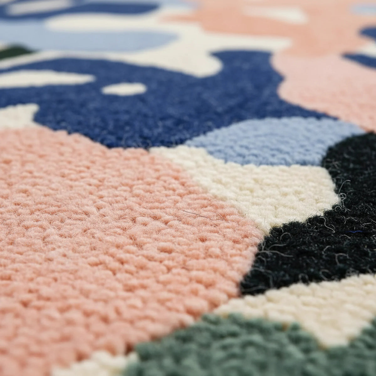 Close-up of a colorful textured rug with geometric patterns.