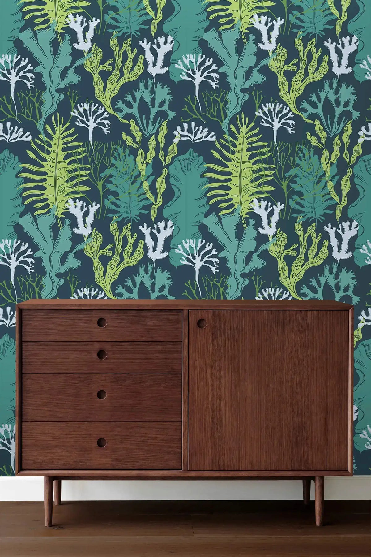 Underwater Flora Wallpaper in deep teal with seaweed motifs above a walnut sideboard