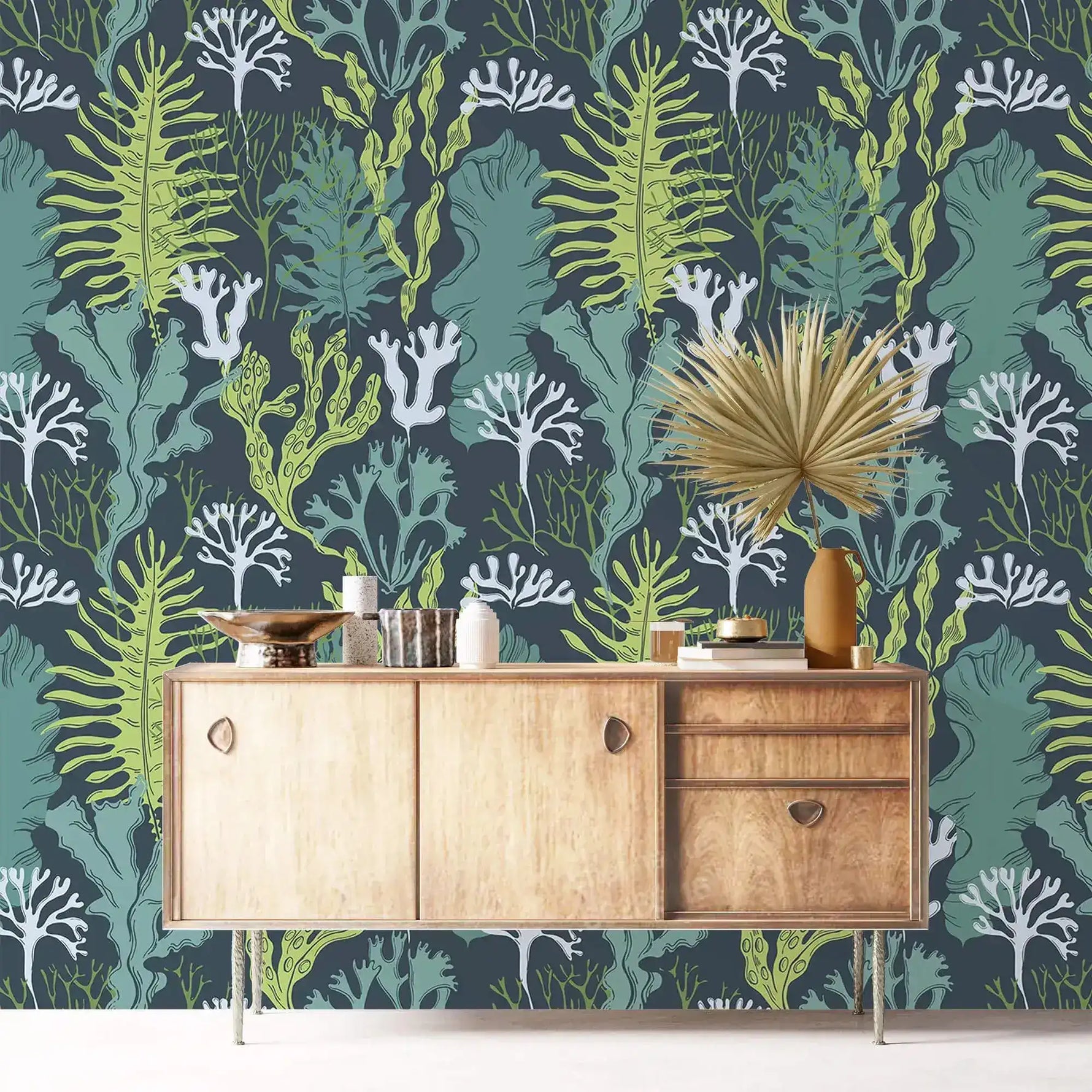 Underwater Flora Wallpaper of green seaweed and white coral on teal behind a wood sideboard