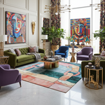 Modern living room with colorful decor, including a green sofa, purple armchair, a contemporary hand-tufted wool rug, and abstract art.