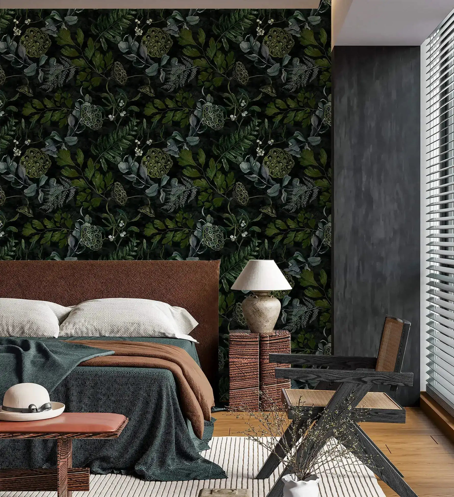 Upholstered bed and urn lamp against enigmatic leafy canopy wallpaper with dark leaves and pods