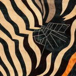 Close-up view of an Urban Abstract Tufted Wool Rug featuring bold, wavy black and beige stripes intermingled with geometric patterns. Perfect for adding a contemporary touch to any living room or office space, this area rug offers a striking design ideal for those seeking modern living room area rugs or rugs for office settings.