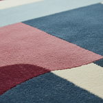 Close-up of a multicolored geometric patterned rug.