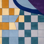 This vibrant Urban Mosaic Hand Tufted Area Rug features a contemporary design with a colorful checkered pattern. Perfect for adding a modern touch to your living room, this wool rug showcases a blend of mustard yellow, teal, and gray squares with bold curves, making it an ideal choice for those seeking stylish rugs for the living room.